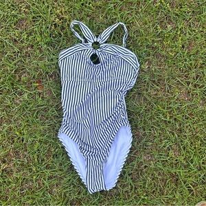 black-and-white striped one-piece swimsuit featuring a decorative ring